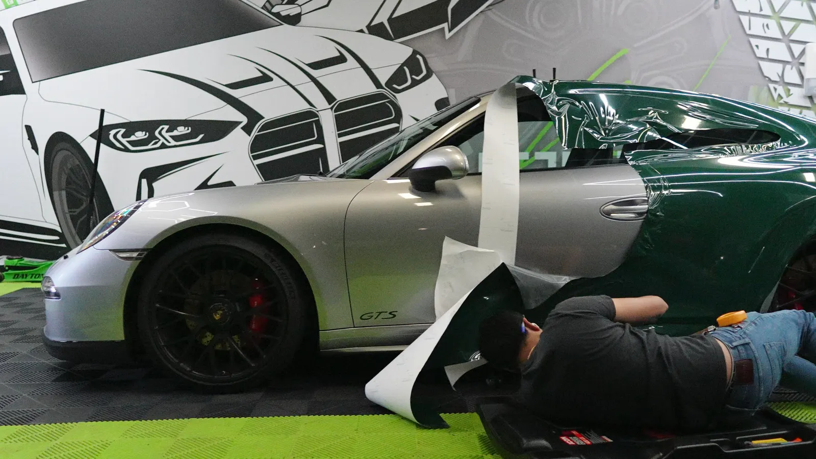 WRP installer laying racing green vinyl on a Porsche 911