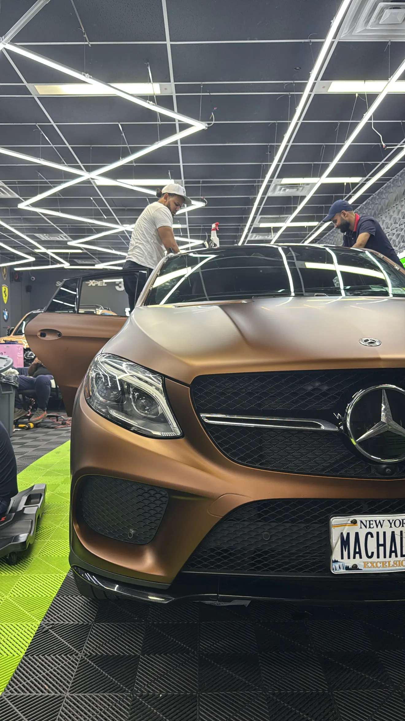 WRP technicians working on a satin bronze Mercedes-AMG GLE