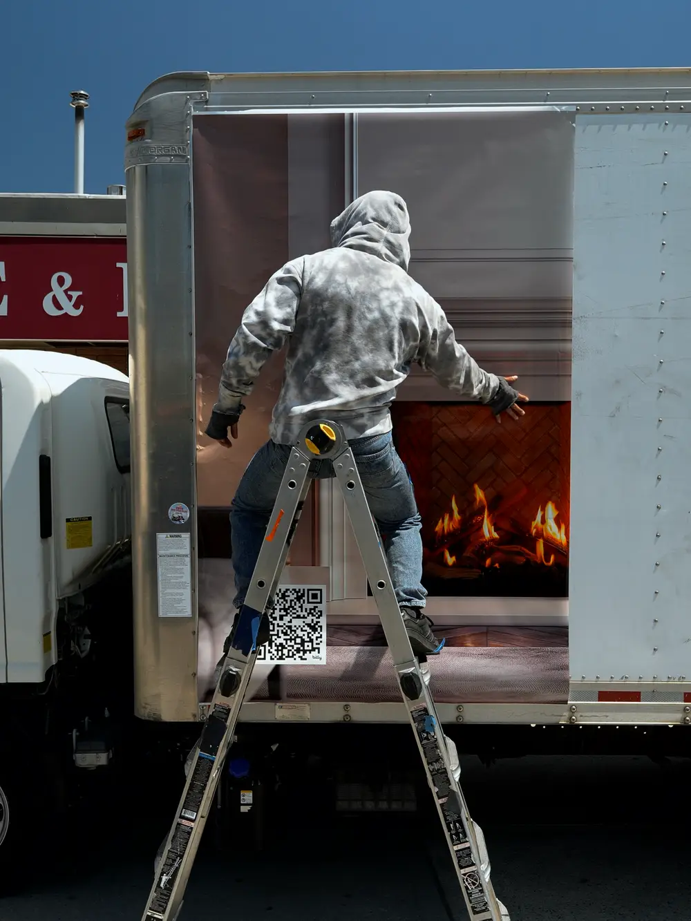 Installer on a ladder applying the printed panel